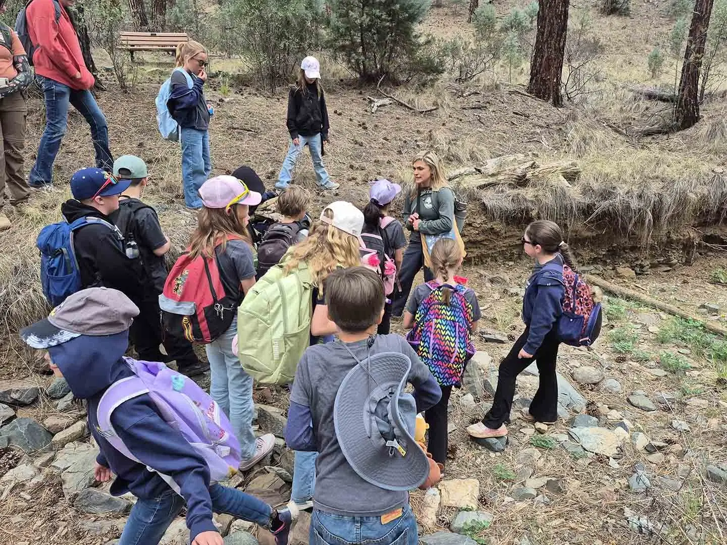Field trip group of students listening about and observing erosion.